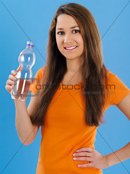 Happy young woman drinking bottled water