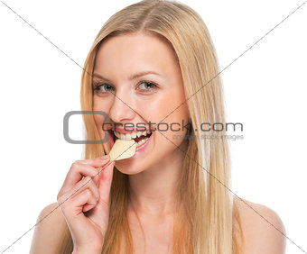 Portrait of happy teenager eating chips