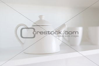 teapot and cups on the shelf