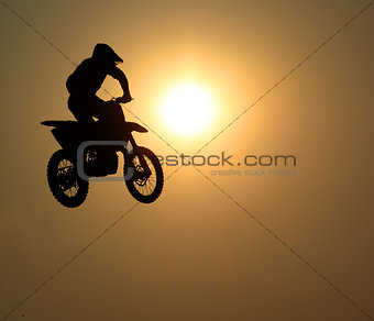 Motorcycle jumps in the air