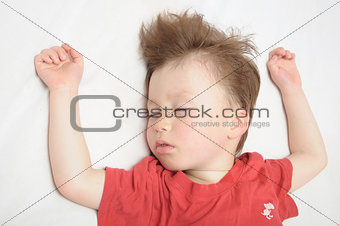 Kid sleeping, arms outstretched