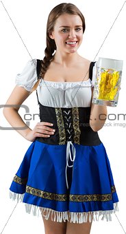 Pretty oktoberfest girl smiling at camera holding beer