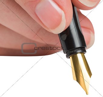 Businesswomans hand writing with fountain pen