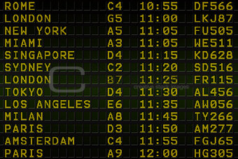 Black airport departures board with yellow text