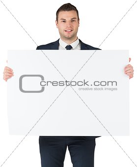 Smiling businessman showing large card