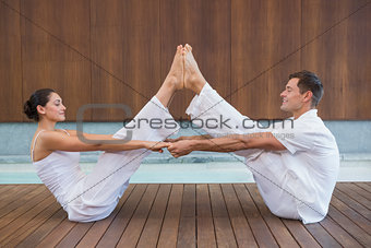 Peaceful couple sitting in boat position together