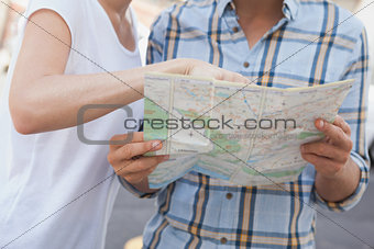 Young tourist couple looking at map