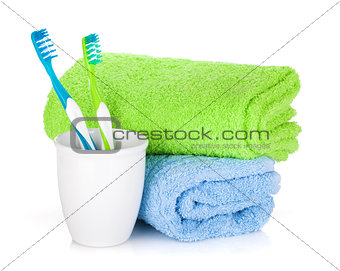 Two colorful toothbrushes and towels