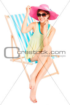 young sunshine girl smiling and sitting on a beach chair