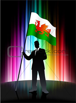 Wales Flag with Businessman on Abstract Spectrum Background
