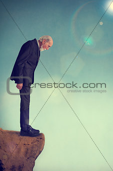 senior man on a cliff ledge