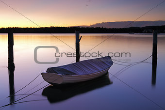 Sunrise at Woy Woy with little boat and moorings