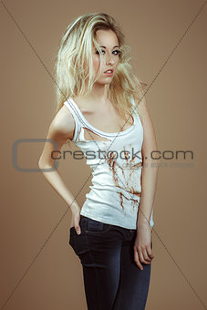 Very Expressive blonde girl in a white torn top