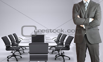 Businessman and conference table with laptops