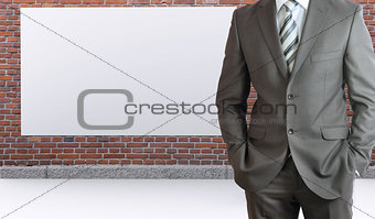 Businessman standing with hands in pockets