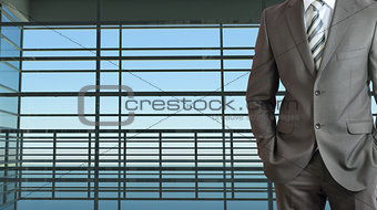 Businessman and large window airport terminal