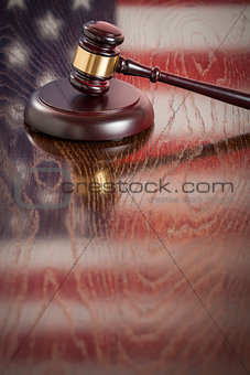 Wooden Gavel Resting on Flag Reflecting Table