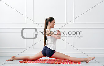 Lifestyle. Beautiful girl during yoga exercise
