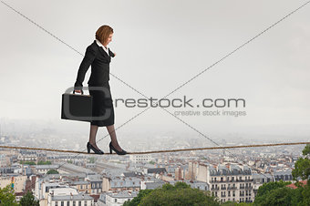 businesswoman walking a tightrope