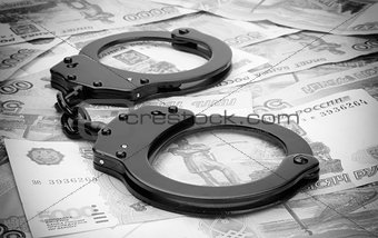 financial crime. Steel handcuffs and money