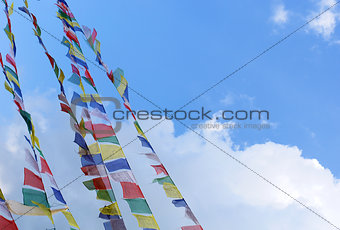 stupa with prayer flags on clear blue sky background