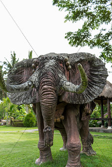 Elephant statue standing on a lawn at a park