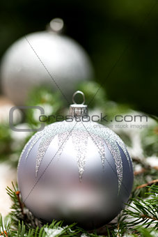 Silver Christmas ornaments in leaves