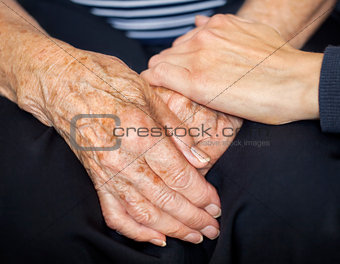 Young hand consoling old hands