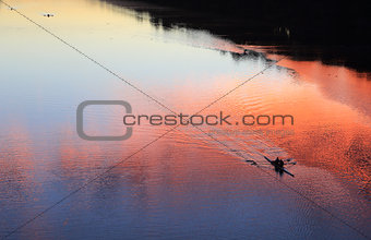 Rowing silhouettes on the river