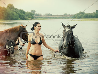  girl bathe horse in a river 