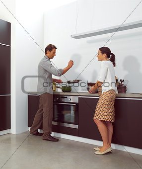 Young couple working in kitchen