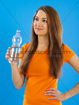 Happy young woman drinking water