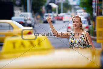 people travelling-business woman stopping yellow taxi