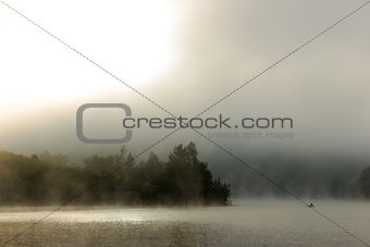 Spectacular deep fog over river at dawn