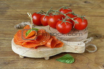 tasty spicy pepperoni sausage on a wooden board
