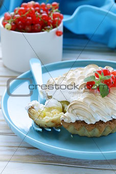 tart with lemon cream and meringue decorated with currants