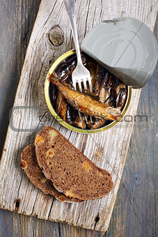 Sprats in a tin and fork.
