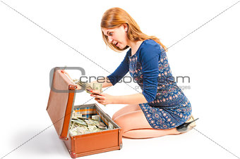 Surprised girl found in a suitcase of money