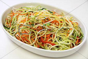 vegetable noodles in a bowl on white