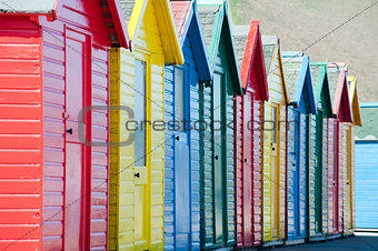 Row of colorful wooden beach huts