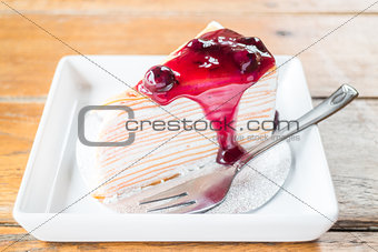 Delicious whipped cream crepe cake with blueberry sauce 
