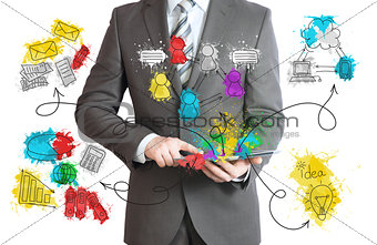 Businessman hold tablet with business sketches