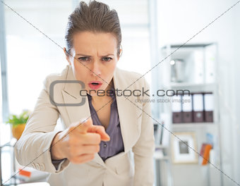 Angry business woman threatening with finger