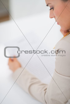Business woman examining document. rear view