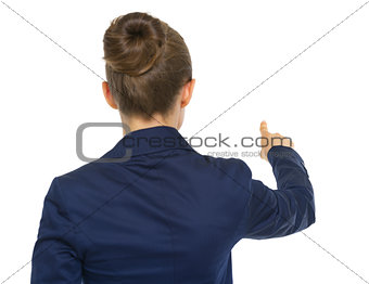 Business woman pointing. rear view