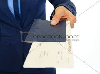 Closeup on business woman giving passport with ticket