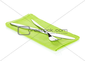Silverware or flatware set of fork and knife over kitchen towel