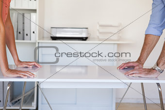 Business partners facing off at desk