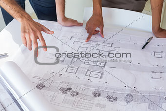 Workers looking at important blueprints