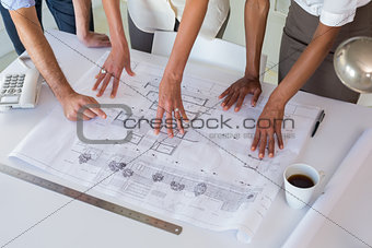 Architects looking at building plans carefully